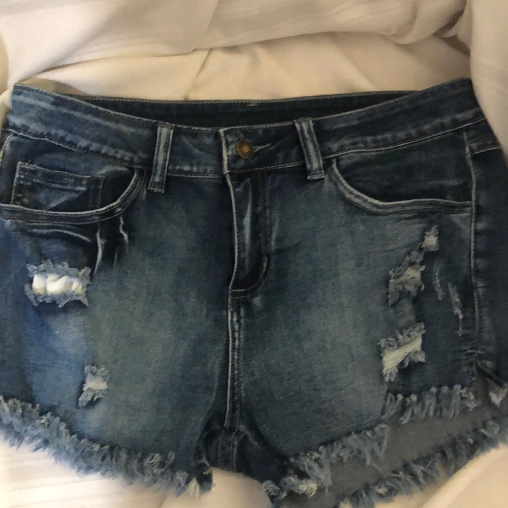 Dark denim distressed shorts.